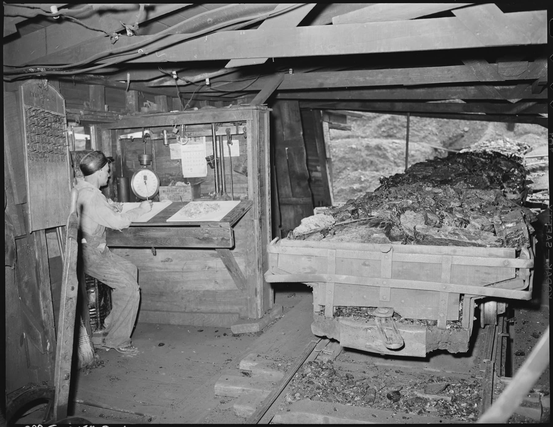 The union's checkweighman recording the tonnage at the tipple, Clover Gap Mine, Harlan County, Kentucky, 1946